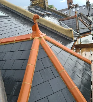 Premium Slate Roof Installation Certified roofer installing natural slate tiles on pitched roof in London